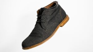 gray and brown suede lace up shoe